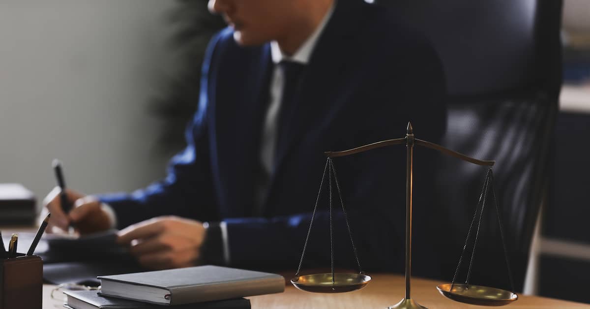 a securities fraud attorney works at his desk | Colling Gilbert Wright